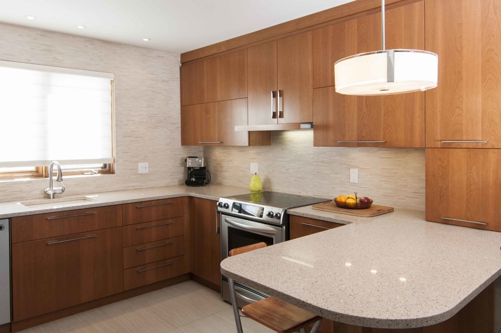 This is an example of a modern kitchen in Montreal with flat-panel cabinets and medium wood cabinets.