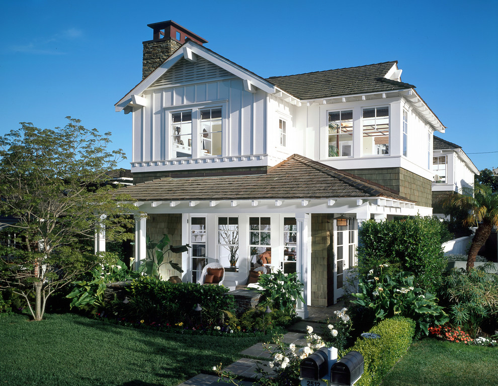 This is an example of a traditional exterior in Orange County with wood siding and a gable roof.