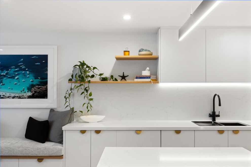 Inspiration for a beach style kitchen in Sunshine Coast with with island.