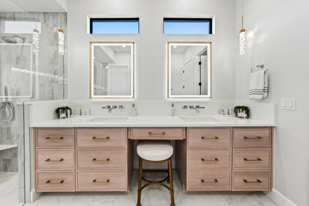 Example of a transitional master gray tile and porcelain tile porcelain tile, white floor and double-sink walk-in shower design with shaker cabinets, light wood cabinets, a two-piece toilet, white walls, an undermount sink, quartz countertops, white countertops, a niche and a built-in vanity