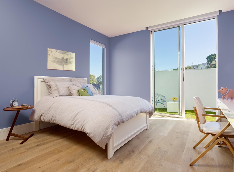 This is an example of a mid-sized modern guest bedroom in San Francisco with light hardwood floors, purple walls and no fireplace.