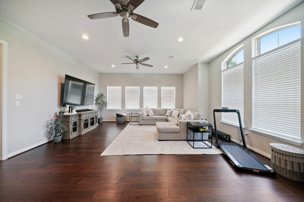 Photo of a mid-sized contemporary open concept living room in Houston with dark hardwood floors.