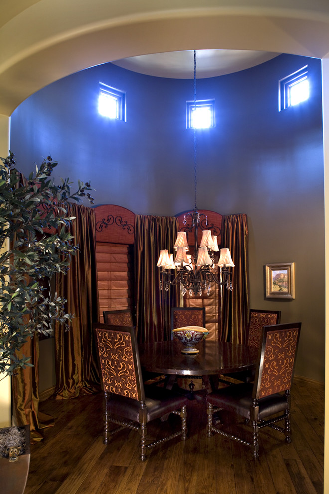 Inspiration for a mediterranean dining room in Phoenix with dark hardwood floors.