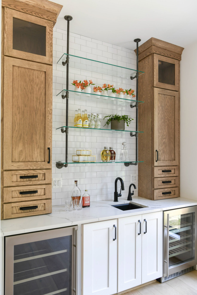 This is an example of a mid-sized contemporary galley home bar in Other with an undermount sink, shaker cabinets, white cabinets, granite benchtops, white splashback, marble splashback, medium hardwood floors and white benchtop.