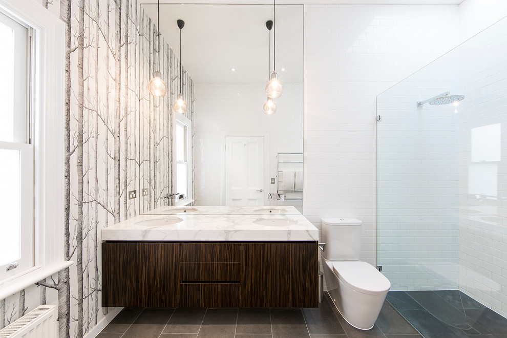 Mid-sized contemporary 3/4 bathroom in Melbourne with an undermount sink, flat-panel cabinets, dark wood cabinets, marble benchtops, a curbless shower, white tile, a two-piece toilet, subway tile and multi-coloured walls.