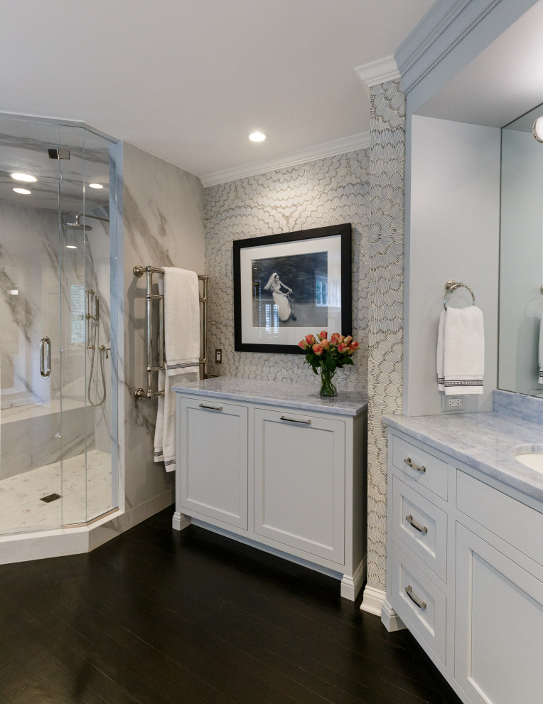 Photo of an expansive transitional master bathroom in New York with recessed-panel cabinets, grey cabinets, a freestanding tub, a double shower, multi-coloured walls, dark hardwood floors, an undermount sink, marble benchtops, a hinged shower door, blue benchtops, an enclosed toilet, a double vanity, a built-in vanity and wallpaper.