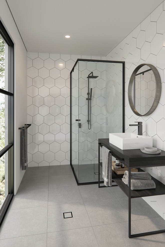 Design ideas for a contemporary 3/4 bathroom in Melbourne with open cabinets, a corner shower, white tile, a vessel sink, grey floor, a hinged shower door and black benchtops.