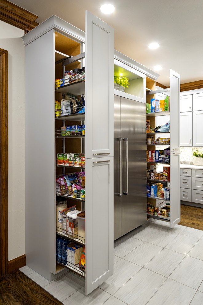 This is an example of a large transitional kitchen pantry in Oklahoma City with shaker cabinets, grey cabinets, stainless steel appliances, medium hardwood floors, with island and brown floor.
