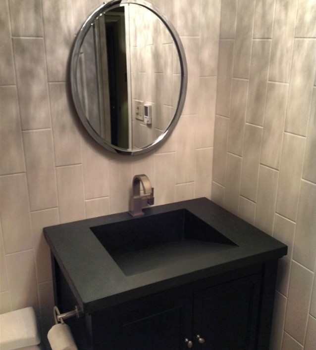Small contemporary bathroom in Philadelphia with dark wood cabinets, a drop-in sink and concrete benchtops.