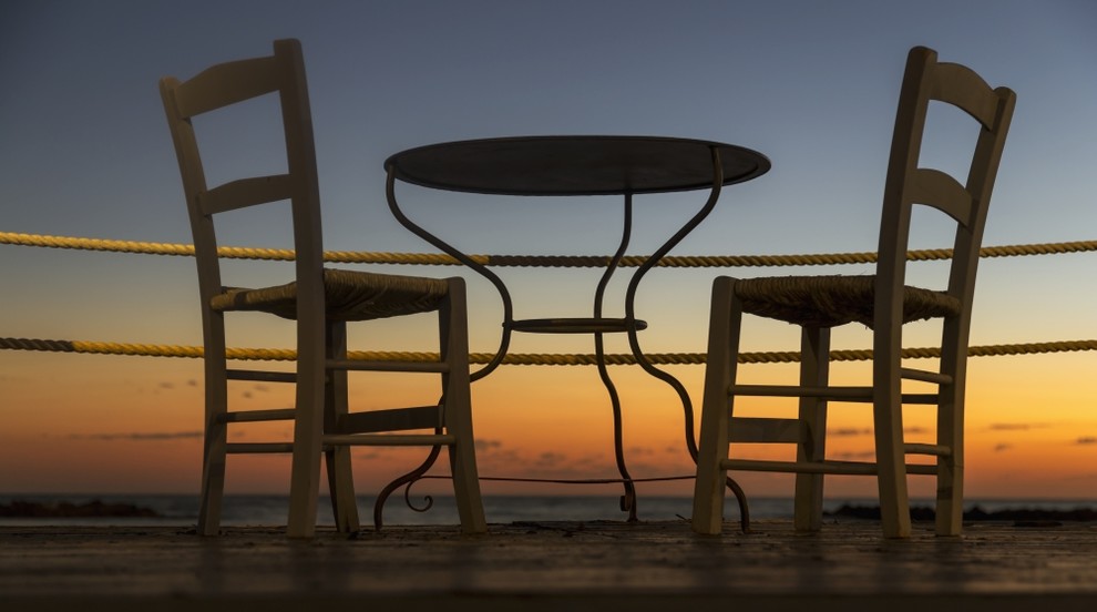 A Table And Chairs On A Patio With A View Of A Colourful Sunset; Paphos Cyprus, 20 x 11 Beach