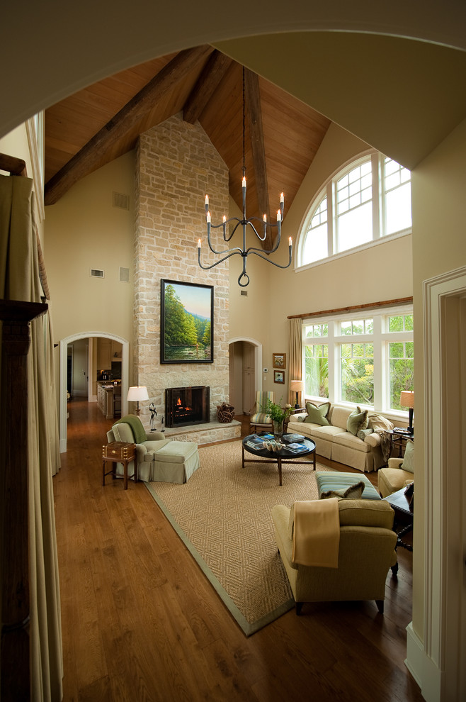 Inspiration for a traditional formal living room in Charleston with beige walls, medium hardwood floors, a standard fireplace, a stone fireplace surround and no tv.