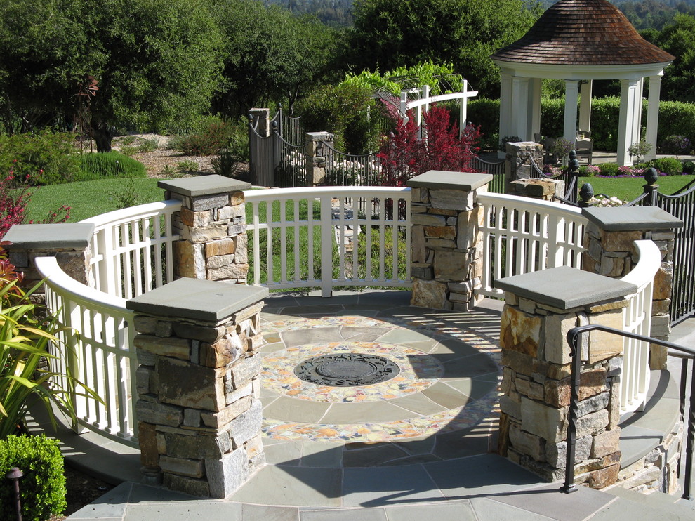 Photo of a large mediterranean patio in San Francisco with natural stone pavers.