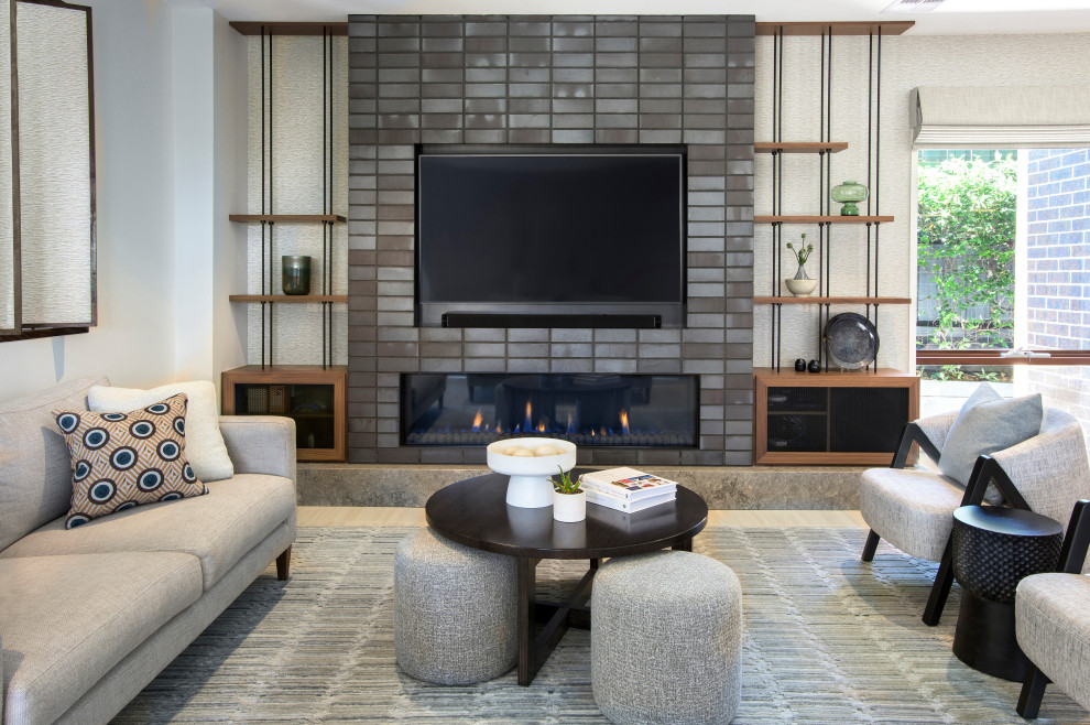 This is an example of a large contemporary open concept living room in Melbourne with porcelain floors, a brick fireplace surround, a built-in media wall, beige floor and wallpaper.