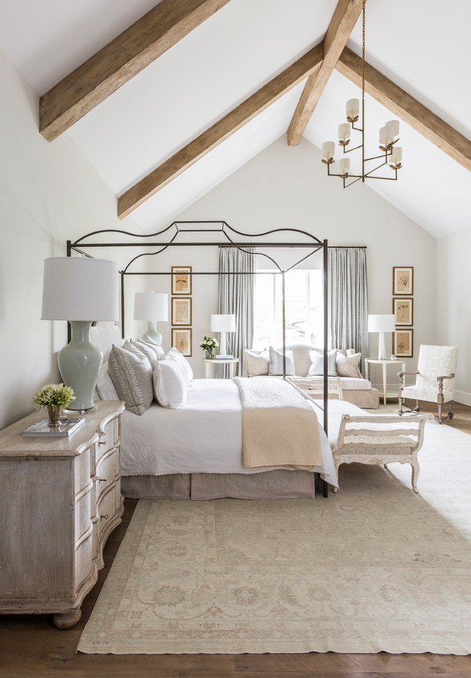 Inspiration for a beach style master bedroom in Houston with grey walls and medium hardwood floors.