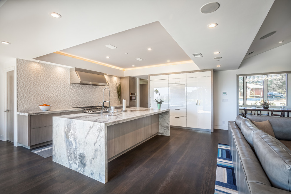 Contemporary l-shaped open plan kitchen in San Francisco with an undermount sink, flat-panel cabinets, grey cabinets, quartzite benchtops, white splashback, ceramic splashback, panelled appliances, dark hardwood floors and with island.
