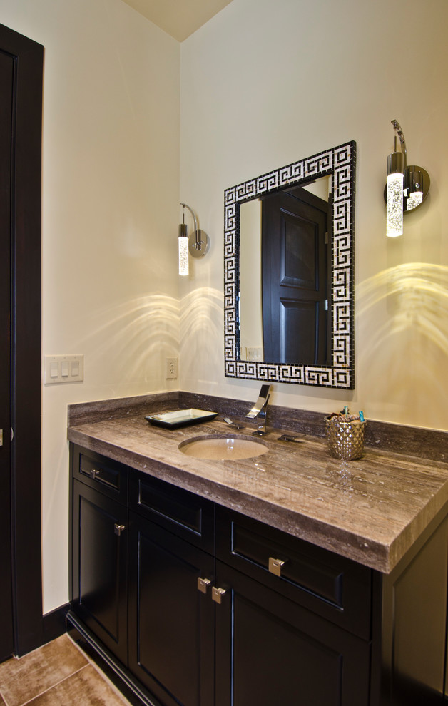 Photo of a large mediterranean powder room in Phoenix with an undermount sink, dark wood cabinets, white walls, travertine floors and recessed-panel cabinets.