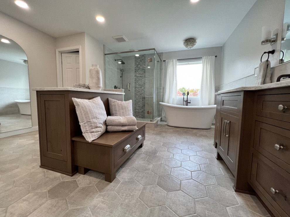 Inspiration for a large transitional master white tile and porcelain tile porcelain tile, gray floor and double-sink freestanding bathtub remodel in Cincinnati with medium tone wood cabinets, white walls, quartz countertops, a hinged shower door, white countertops and a built-in vanity