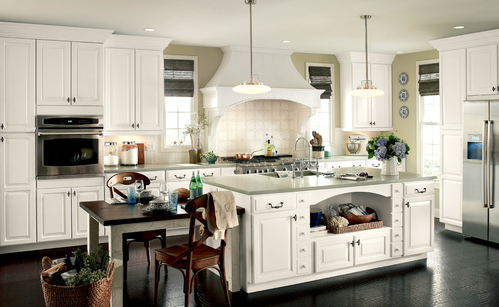 Inspiration for a mid-sized transitional enclosed kitchen remodel with a single-bowl sink, raised-panel cabinets, white cabinets, quartzite countertops, white backsplash, stainless steel appliances and an island
