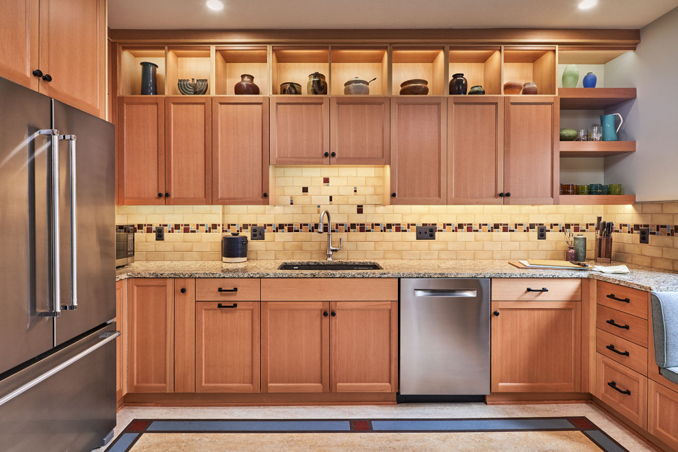 This is an example of a mid-sized arts and crafts u-shaped separate kitchen in Other with an undermount sink, recessed-panel cabinets, medium wood cabinets, granite benchtops, multi-coloured splashback, ceramic splashback, linoleum floors, no island, multi-coloured floor and multi-coloured benchtop.