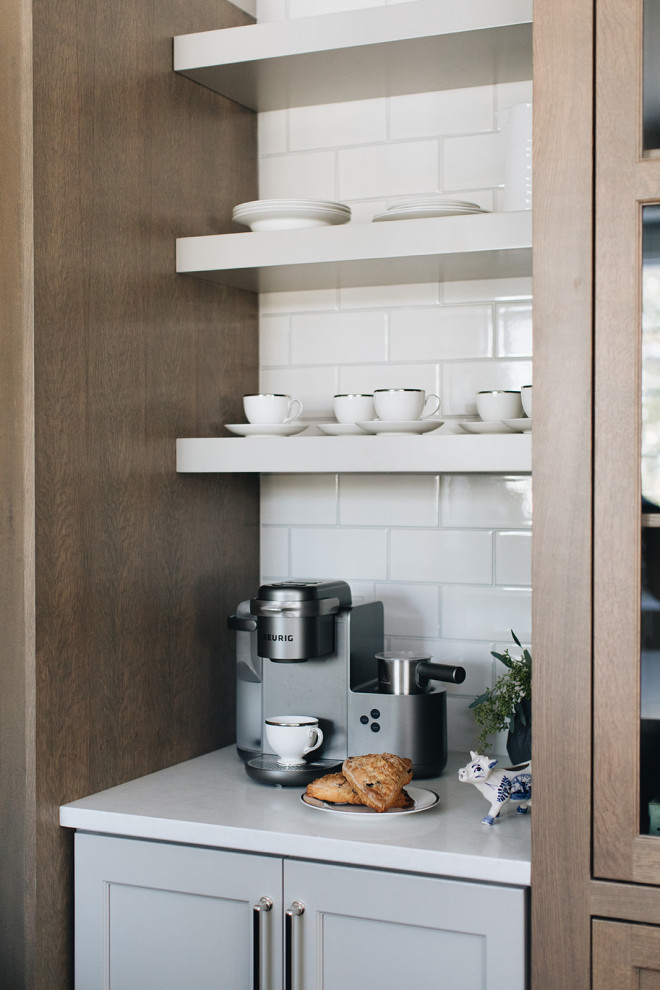 Inspiration for a mid-sized transitional dark wood floor eat-in kitchen remodel in Chicago with a farmhouse sink, shaker cabinets, gray cabinets, quartz countertops, white backsplash, ceramic backsplash, paneled appliances, an island and white countertops