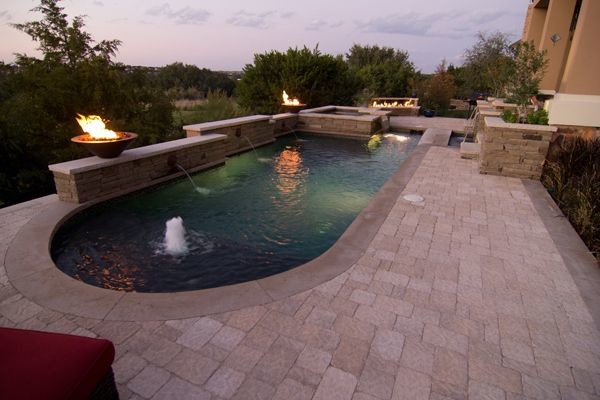 This is an example of an eclectic backyard custom-shaped pool in Austin.