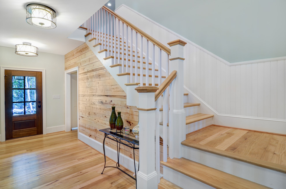 Inspiration for a large transitional light wood floor and beige floor front door remodel in Baltimore with gray walls and a medium wood front door