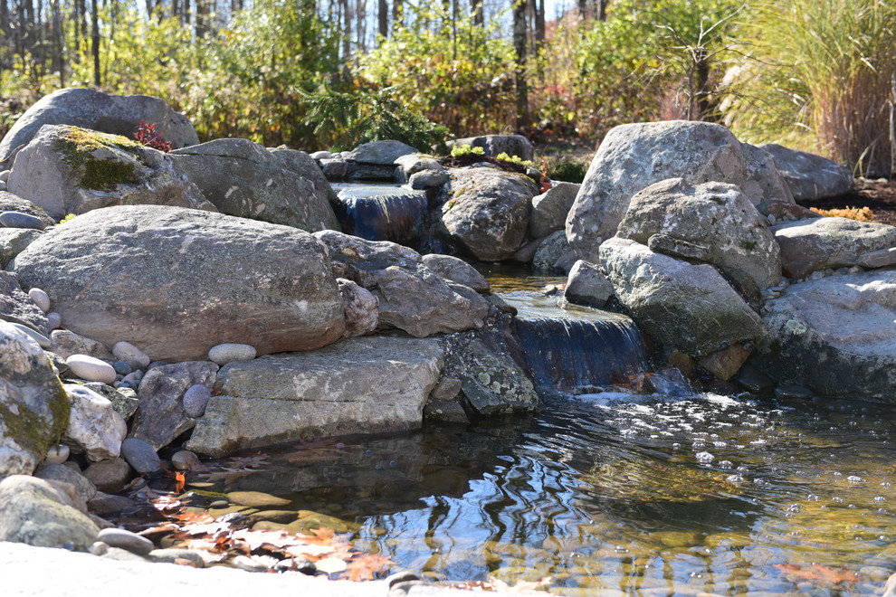 Photo of a large rustic hillside stone water fountain landscape in Boston.