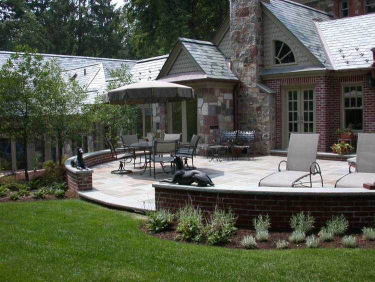 Large traditional patio in Other with natural stone pavers.