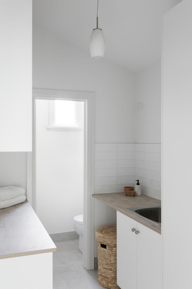 This is an example of a transitional laundry room in Melbourne.