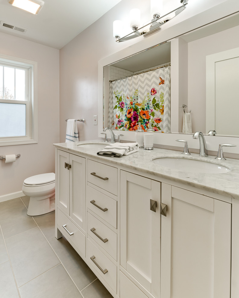 Design ideas for a small contemporary bathroom in Columbus with an undermount sink, flat-panel cabinets, white cabinets, marble benchtops, a corner tub, a shower/bathtub combo, a two-piece toilet, gray tile, ceramic tile, purple walls and porcelain floors.