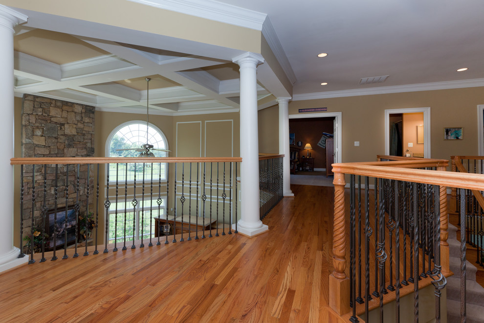 Photo of a traditional hallway in DC Metro with beige walls and medium hardwood floors.