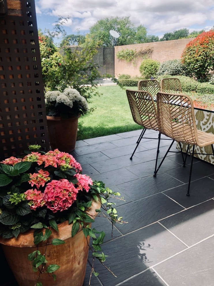 This is an example of a mid-sized country backyard verandah in Madrid with a container garden.