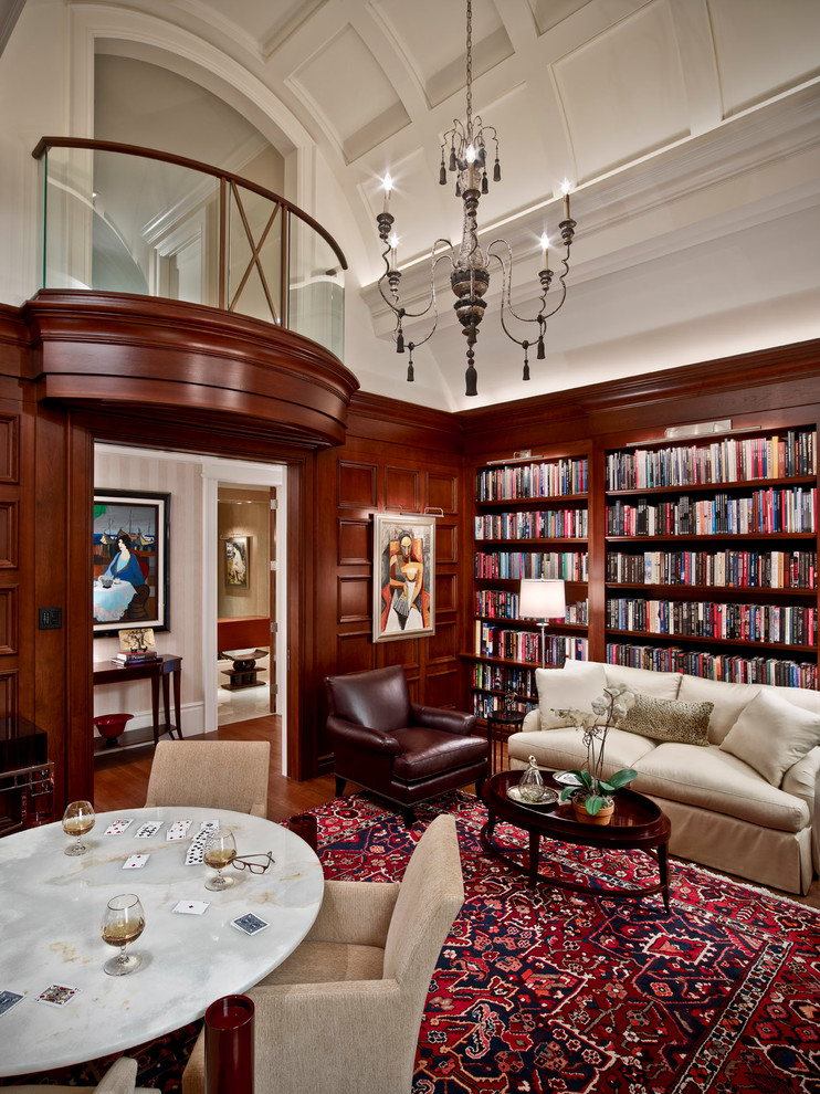 Traditional family room in Detroit with a library, white walls and dark hardwood floors.