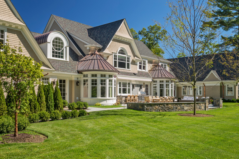 Design ideas for a traditional two-storey beige exterior in Boston with wood siding and a gable roof.