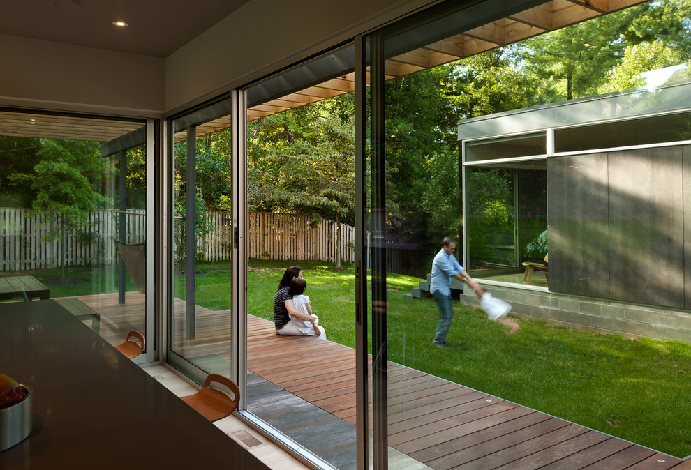 Inspiration for a modern side yard deck in DC Metro with a roof extension.