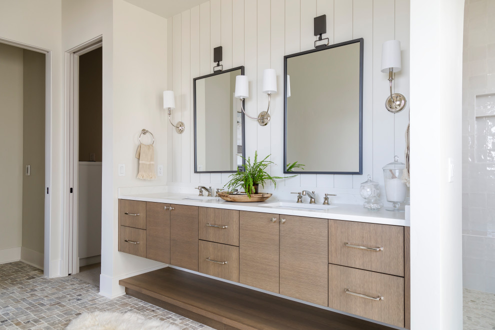 Photo of a mid-sized country master bathroom in Boise with flat-panel cabinets, medium wood cabinets, a freestanding tub, an open shower, porcelain tile, white walls, travertine floors, an undermount sink, engineered quartz benchtops, an open shower, white benchtops, a double vanity, a floating vanity and planked wall panelling.