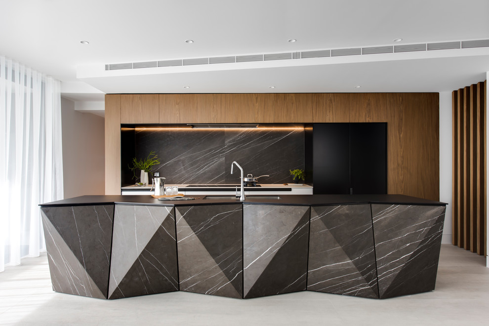 Inspiration for a large contemporary galley kitchen pantry in Sydney with a double-bowl sink, flat-panel cabinets, white cabinets, recycled glass benchtops, grey splashback, marble splashback, black appliances, porcelain floors, with island, grey floor and black benchtop.