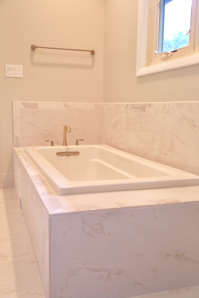 Design ideas for a large transitional master bathroom in Houston with shaker cabinets, grey cabinets, a drop-in tub, a corner shower, a two-piece toilet, white tile, marble, grey walls, ceramic floors, an undermount sink, marble benchtops, white floor and a hinged shower door.