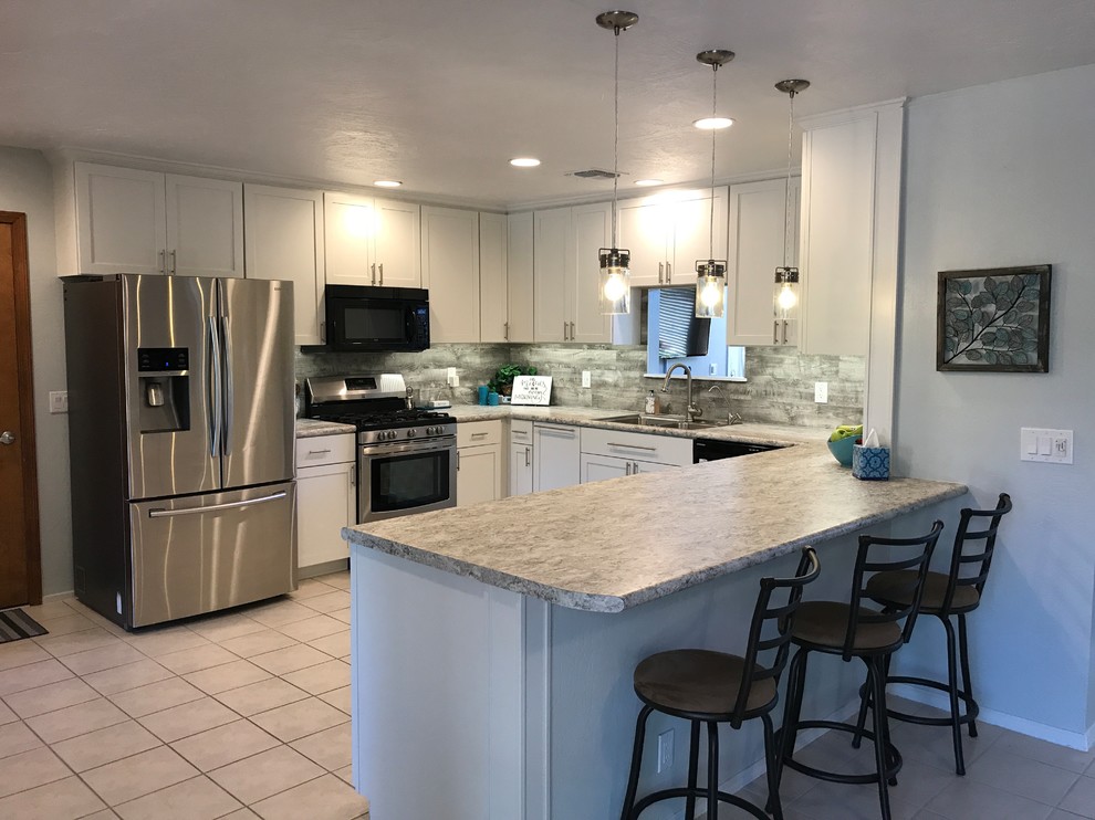 Inspiration for a mid-sized transitional u-shaped ceramic tile and white floor eat-in kitchen remodel in Phoenix with an undermount sink, shaker cabinets, white cabinets, granite countertops, gray backsplash, stone tile backsplash, stainless steel appliances and a peninsula