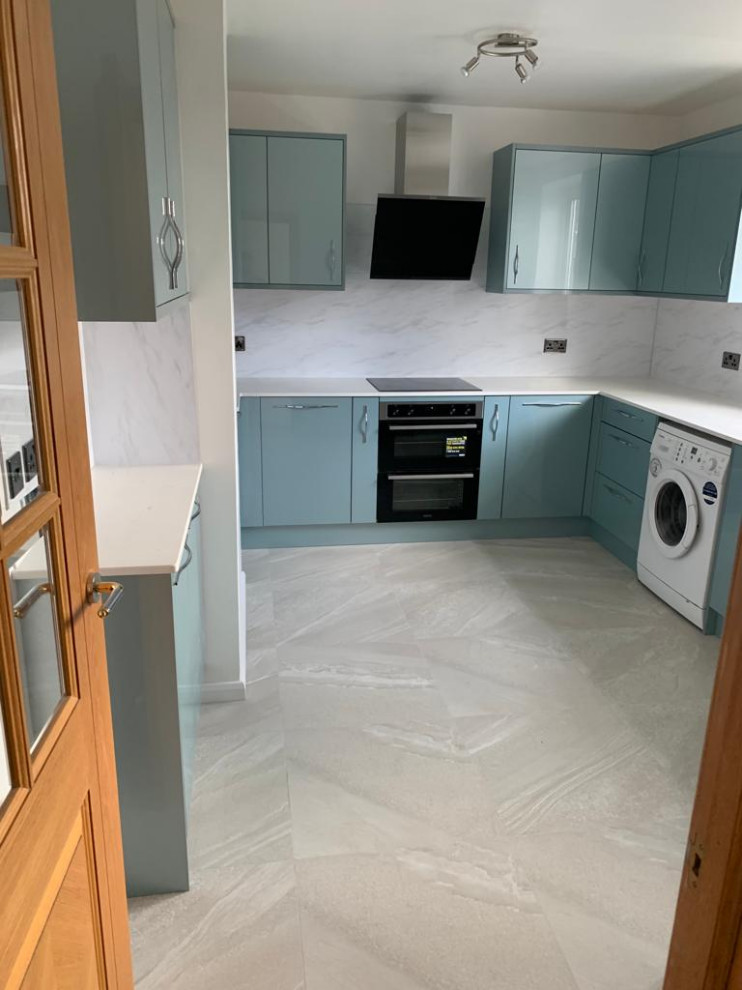 Inspiration for a small modern l-shaped enclosed kitchen in Hertfordshire with flat-panel cabinets, blue cabinets, ceramic flooring, beige floors and beige worktops.