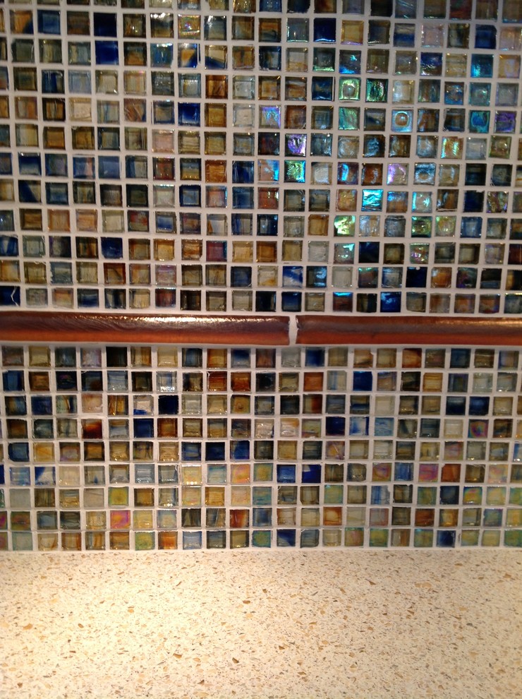 Mid-sized transitional u-shaped medium tone wood floor eat-in kitchen photo in San Diego with solid surface countertops, mosaic tile backsplash, an integrated sink, raised-panel cabinets, medium tone wood cabinets, multicolored backsplash, stainless steel appliances and a peninsula