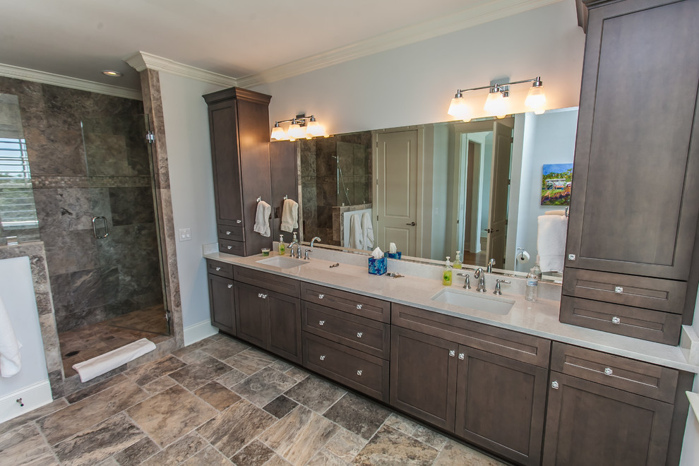 Photo of a mid-sized arts and crafts master bathroom in Wilmington with recessed-panel cabinets, brown cabinets, a double shower, beige tile, porcelain tile, blue walls, an undermount sink, engineered quartz benchtops and a hinged shower door.