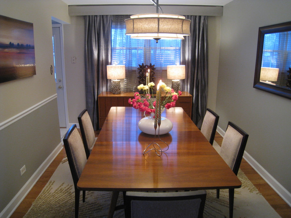 Inspiration for an eclectic separate dining room in Chicago with grey walls and medium hardwood floors.