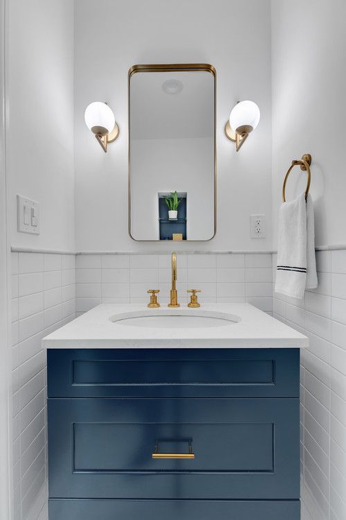 navy blue vanity in a small white bathroom