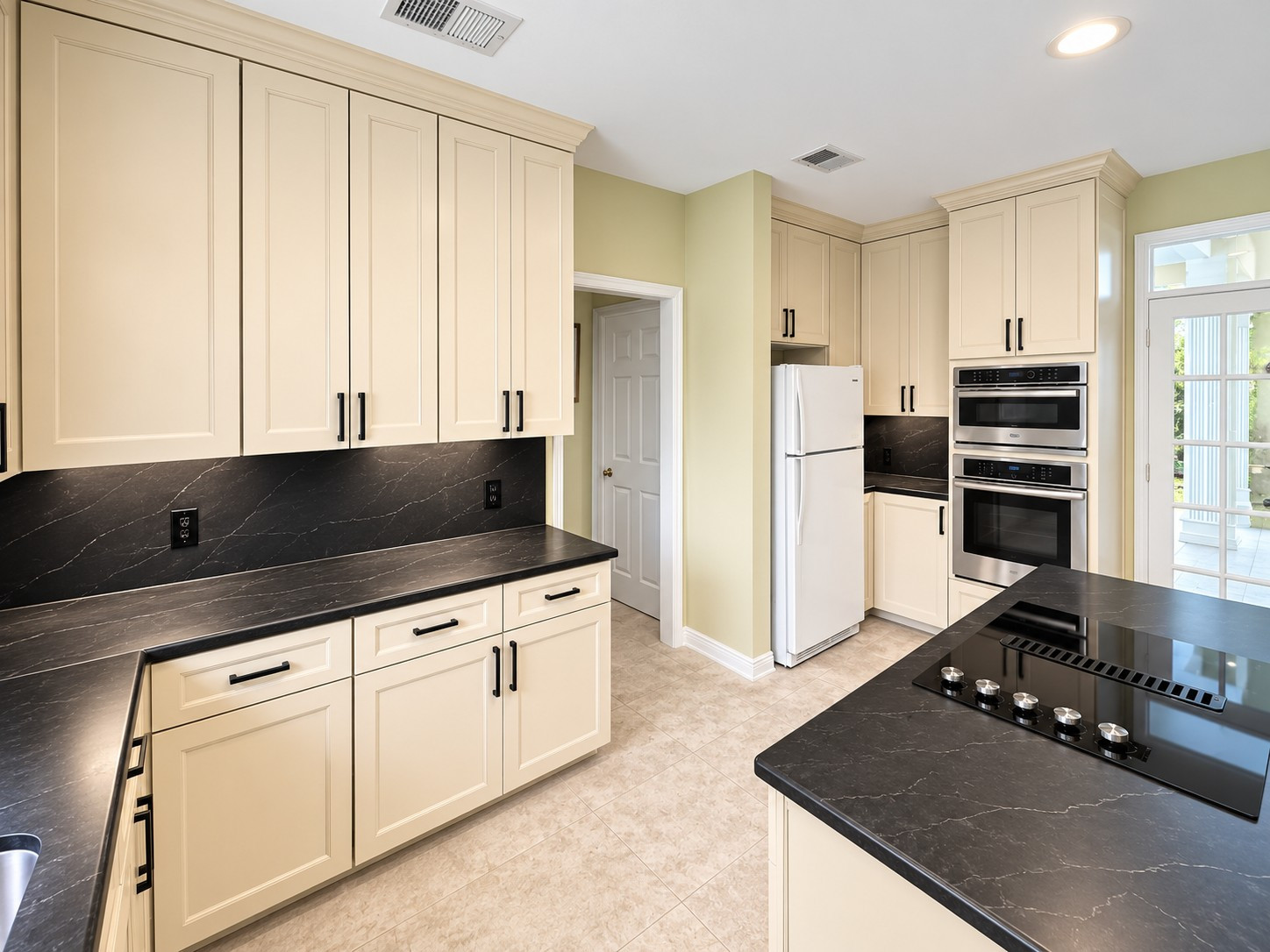 Custom Transitional Kitchen with Cream Shaker Cabinets & Black Countertops