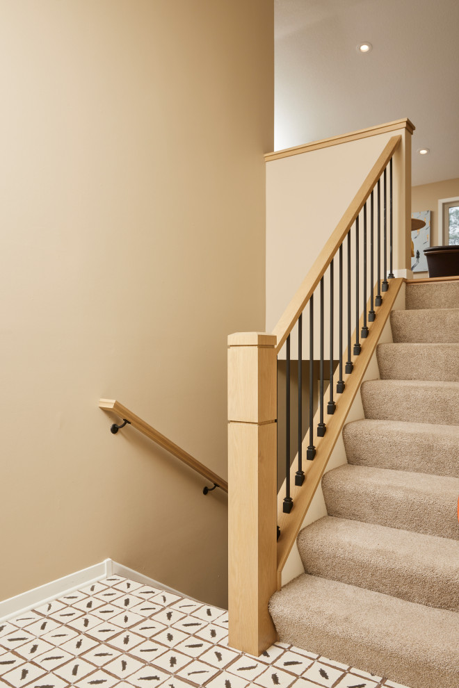 Photo of a mid-sized carpeted straight staircase in Minneapolis with carpet risers and mixed railing.