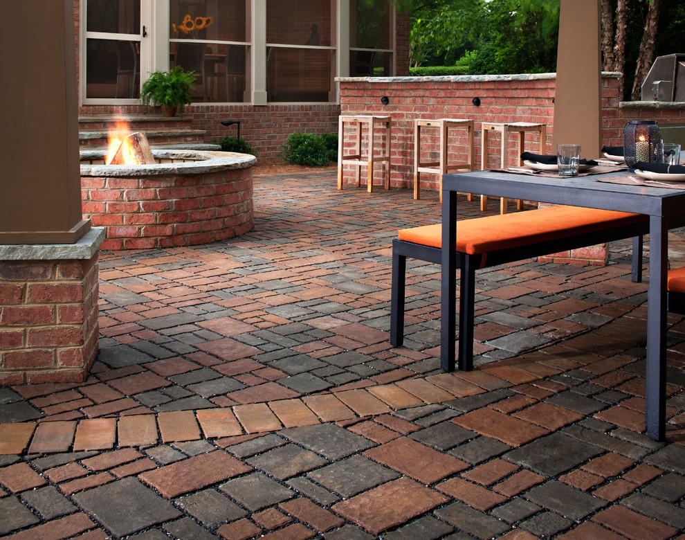 Mid-sized traditional backyard patio in Cincinnati with a fire feature, natural stone pavers and no cover.