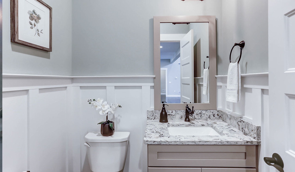 Large country powder room in Other with grey cabinets, a one-piece toilet, grey walls, medium hardwood floors, an undermount sink, engineered quartz benchtops and grey benchtops.