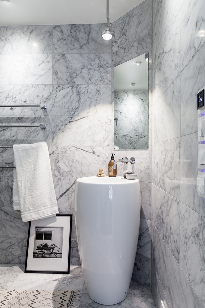 Photo of a mid-sized contemporary bathroom in Stockholm with gray tile, grey walls and marble floors.