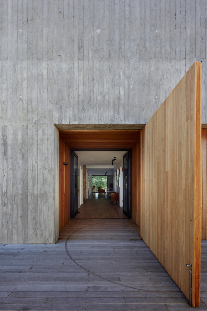 Inspiration for a midcentury front door in Los Angeles with grey walls, a double front door, a glass front door and grey floor.